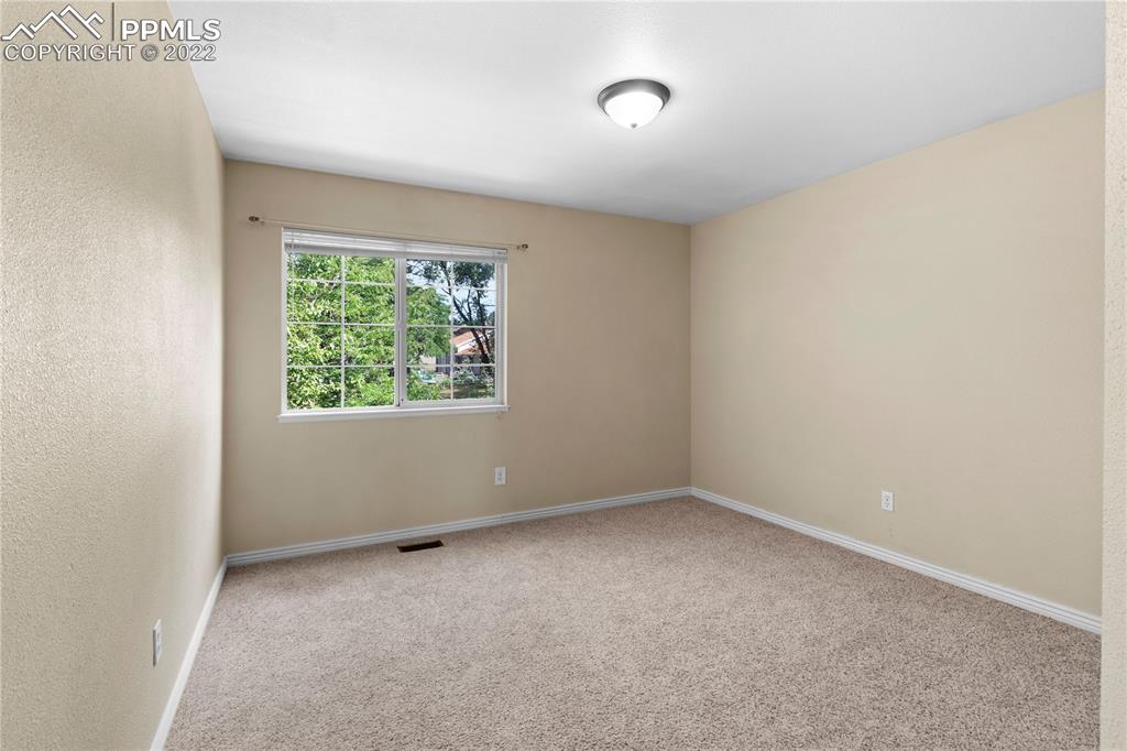 6910 Los Reyes Circle Colorado Springs, CO 80918 - Photo 20 of 38 an empty room with a window