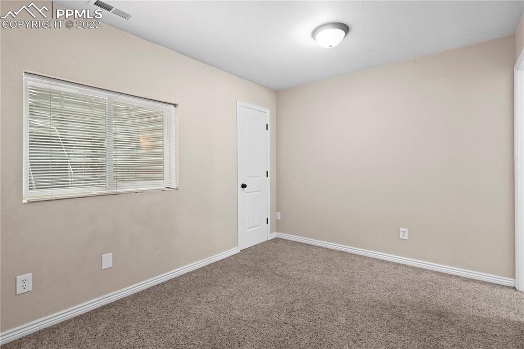 6910 Los Reyes Circle Colorado Springs, CO 80918 - Photo 21 of 38 an empty room with a window