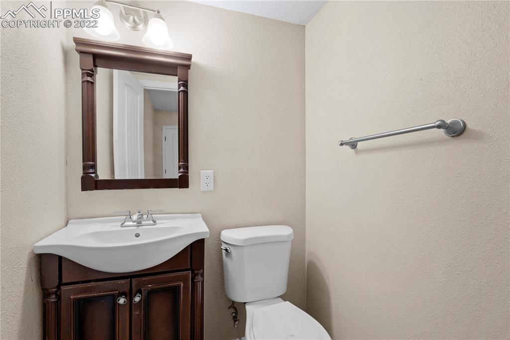6910 Los Reyes Circle Colorado Springs, CO 80918 - Photo 23 of 38 a bathroom with a sink toilet and vanity