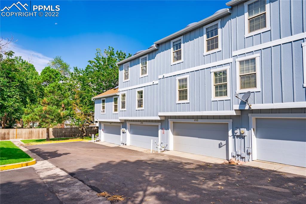 6910 Los Reyes Circle Colorado Springs, CO 80918 - Photo 24 of 38 a front view of a house with a yard and garage
