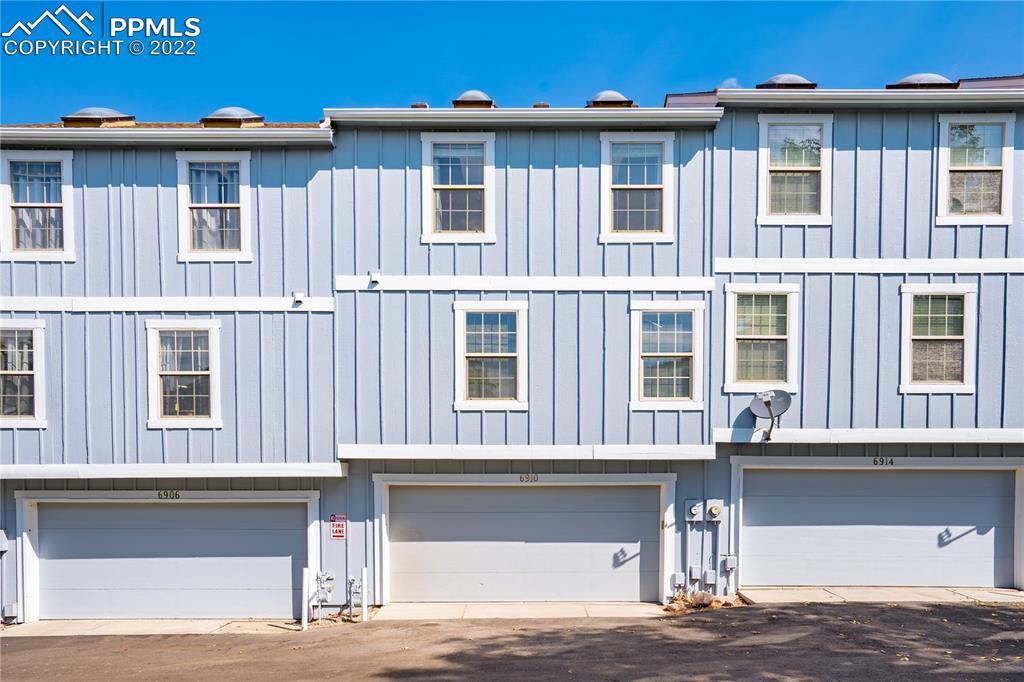 6910 Los Reyes Circle Colorado Springs, CO 80918 - Photo 25 of 38 a front view of a house with a garage