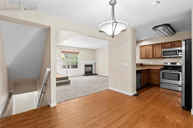 a view of kitchen with sink microwave and refrigerator