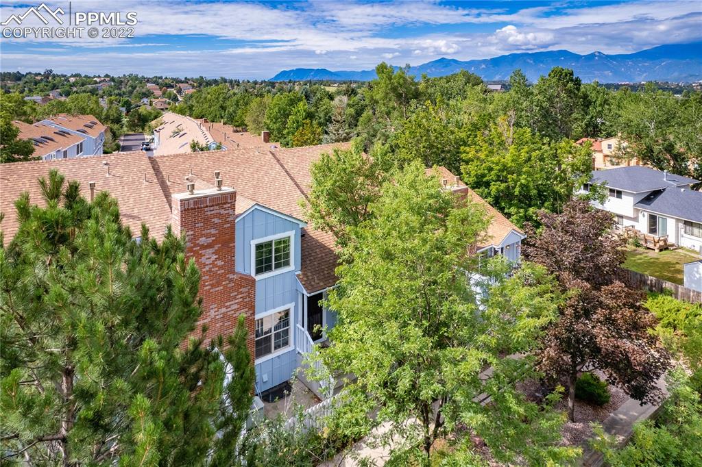 6910 Los Reyes Circle Colorado Springs, CO 80918 - Photo 38 of 38 an aerial view of a house with a yard and mountain view in back