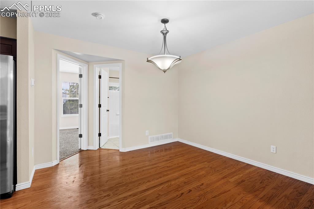 6910 Los Reyes Circle Colorado Springs, CO 80918 - Photo 7 of 38 wooden floor in an empty room