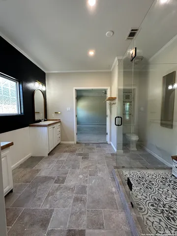 a view of a hallway of a livingroom with furniture and chandelier fan