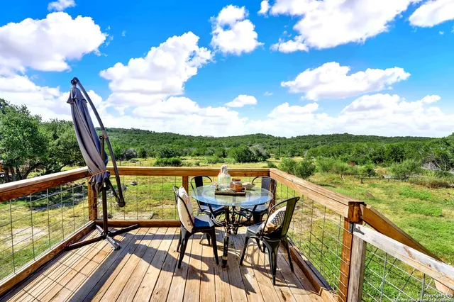 a view of a balcony with mountain view and sitting space