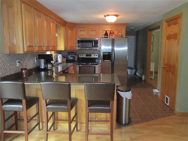 65 Carruth Road Templeton, MA 01468 - Photo 12 of 19 a kitchen with a table chairs refrigerator and microwave