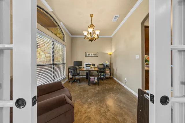 a dining room with furniture and a chandelier