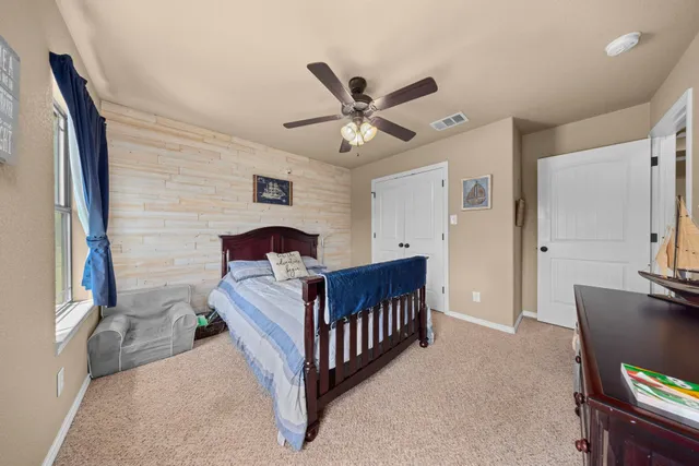 a bedroom with furniture and a window