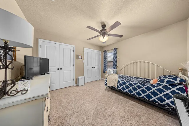 a room with a baby bed a couch and dresser