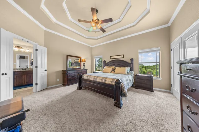 a bedroom with a large bed a chandelier and closet