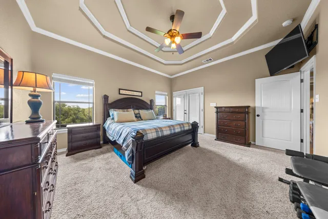 a bedroom with a bed and a chandelier