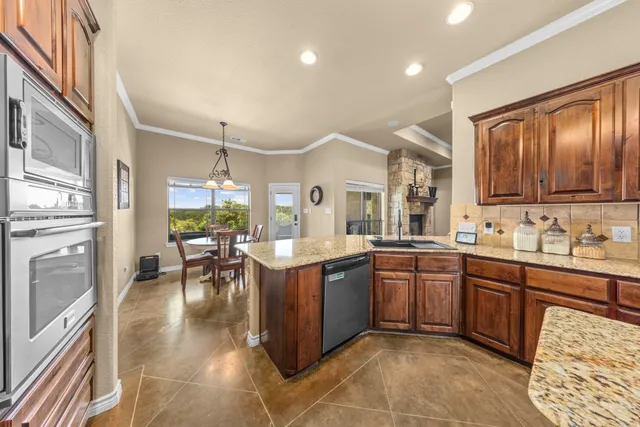 a large kitchen with cabinets a sink and appliances