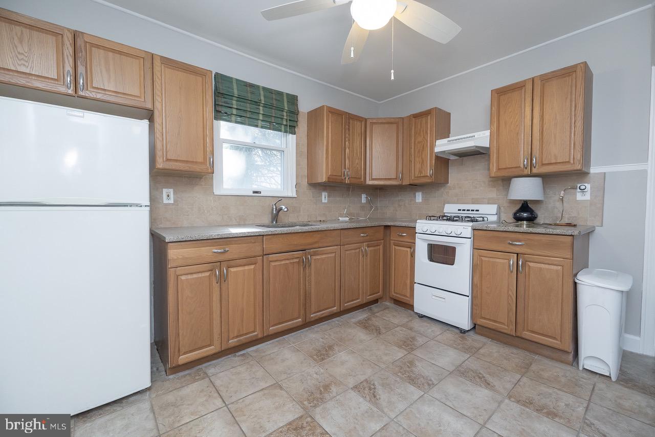 242 Sunset Road Runnemede, NJ 08007 - Photo 10 of 27 a kitchen with a white cabinets stove top oven and sink