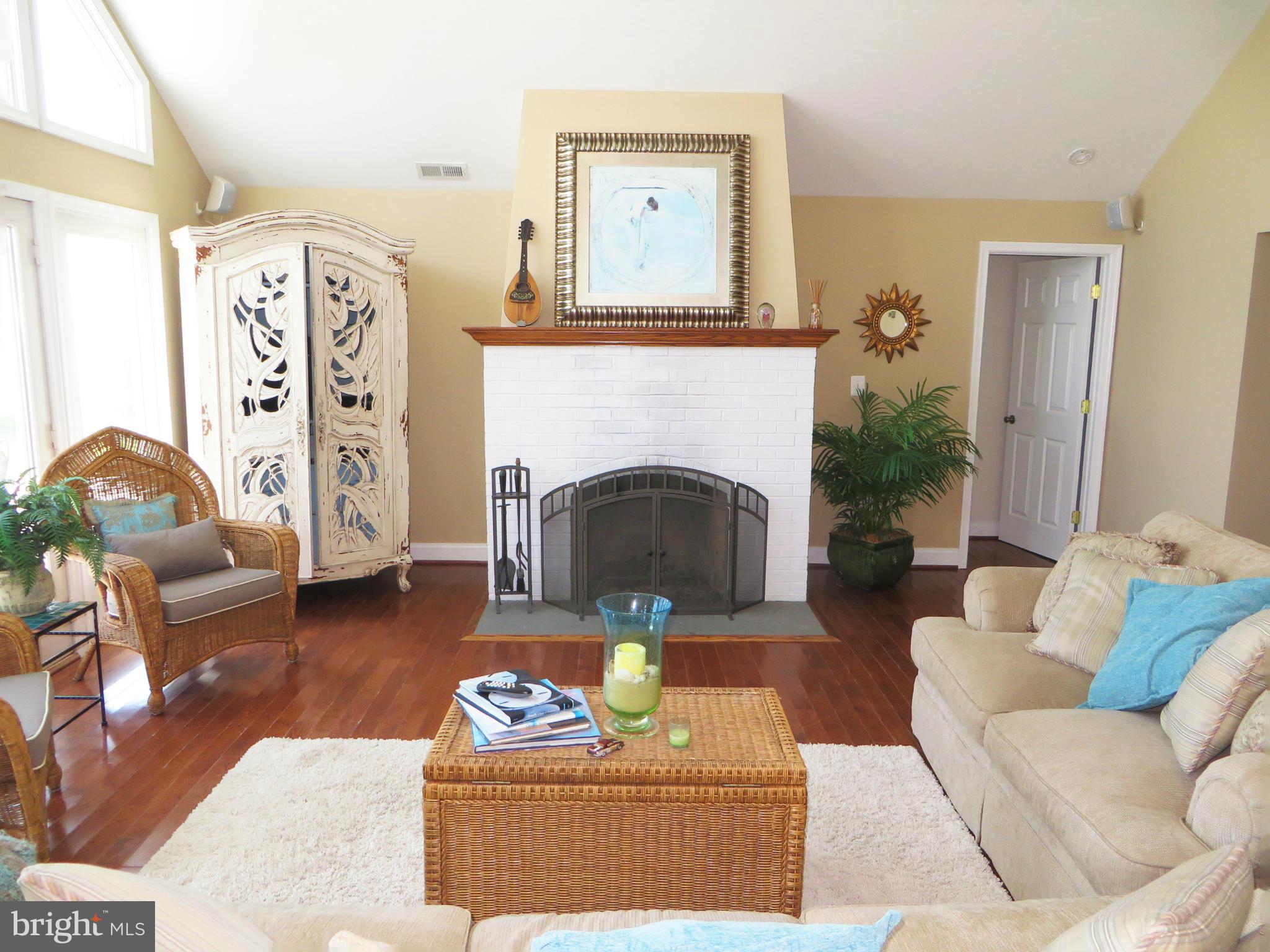 16144 Murray Road Ridge, MD 20680 - Photo 16 of 30 a living room with furniture and a fireplace