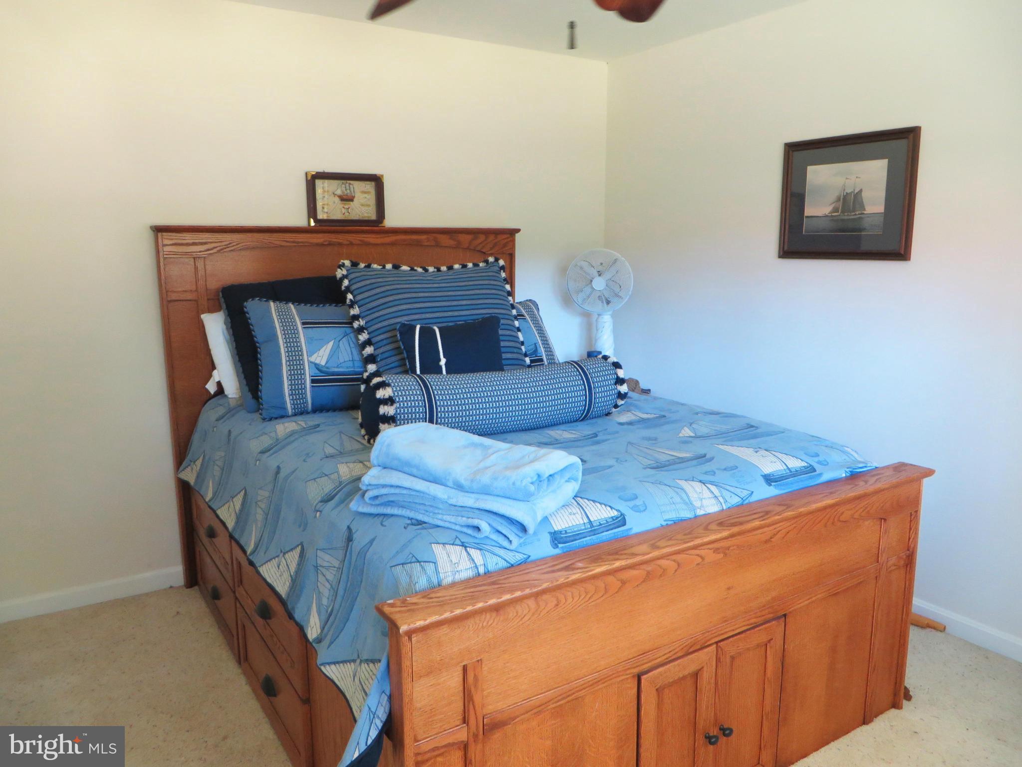 16144 Murray Road Ridge, MD 20680 - Photo 23 of 30 a bedroom with a bed and small cabinet
