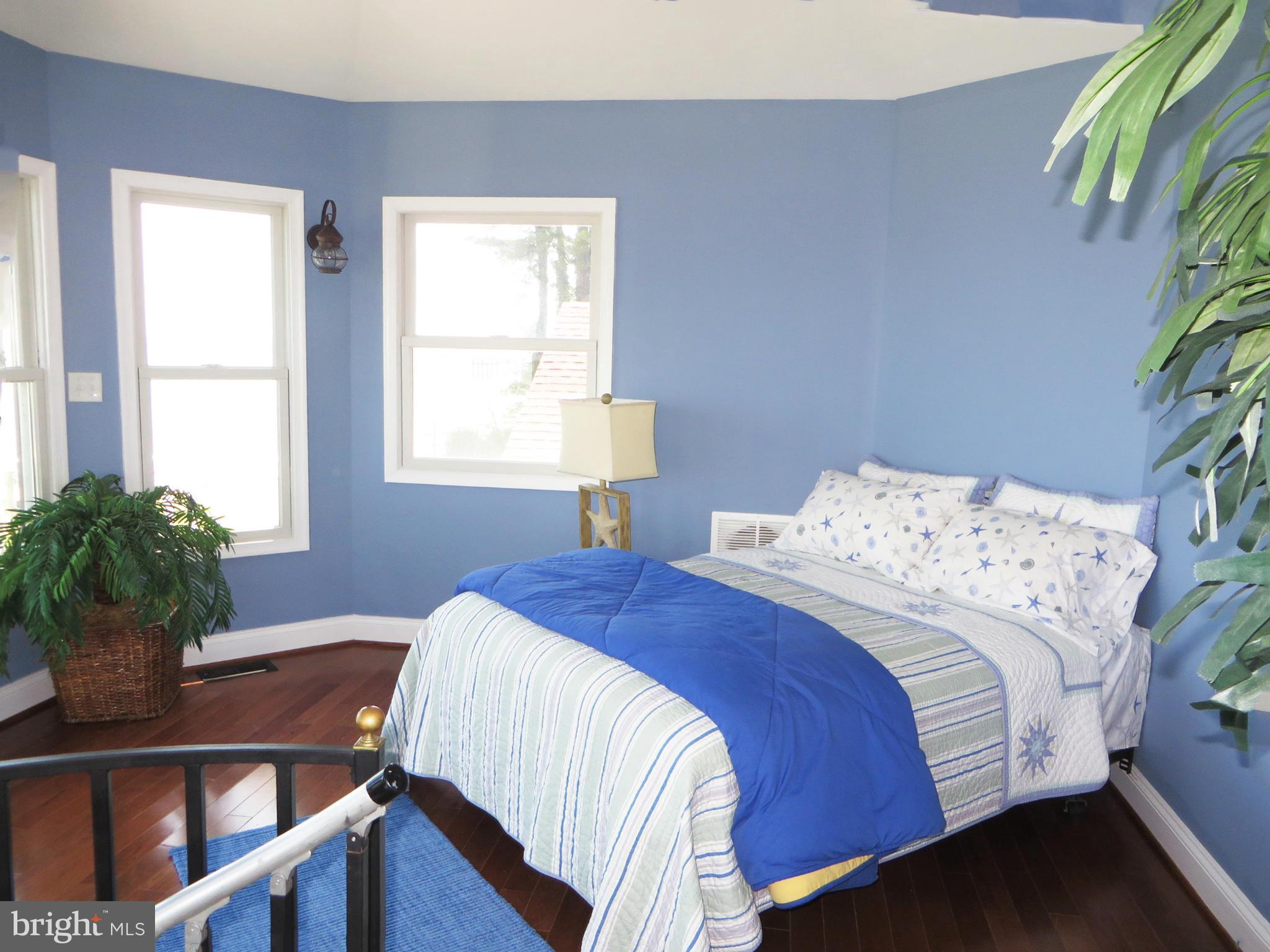 16144 Murray Road Ridge, MD 20680 - Photo 24 of 30 a bedroom with a bed and a potted plant