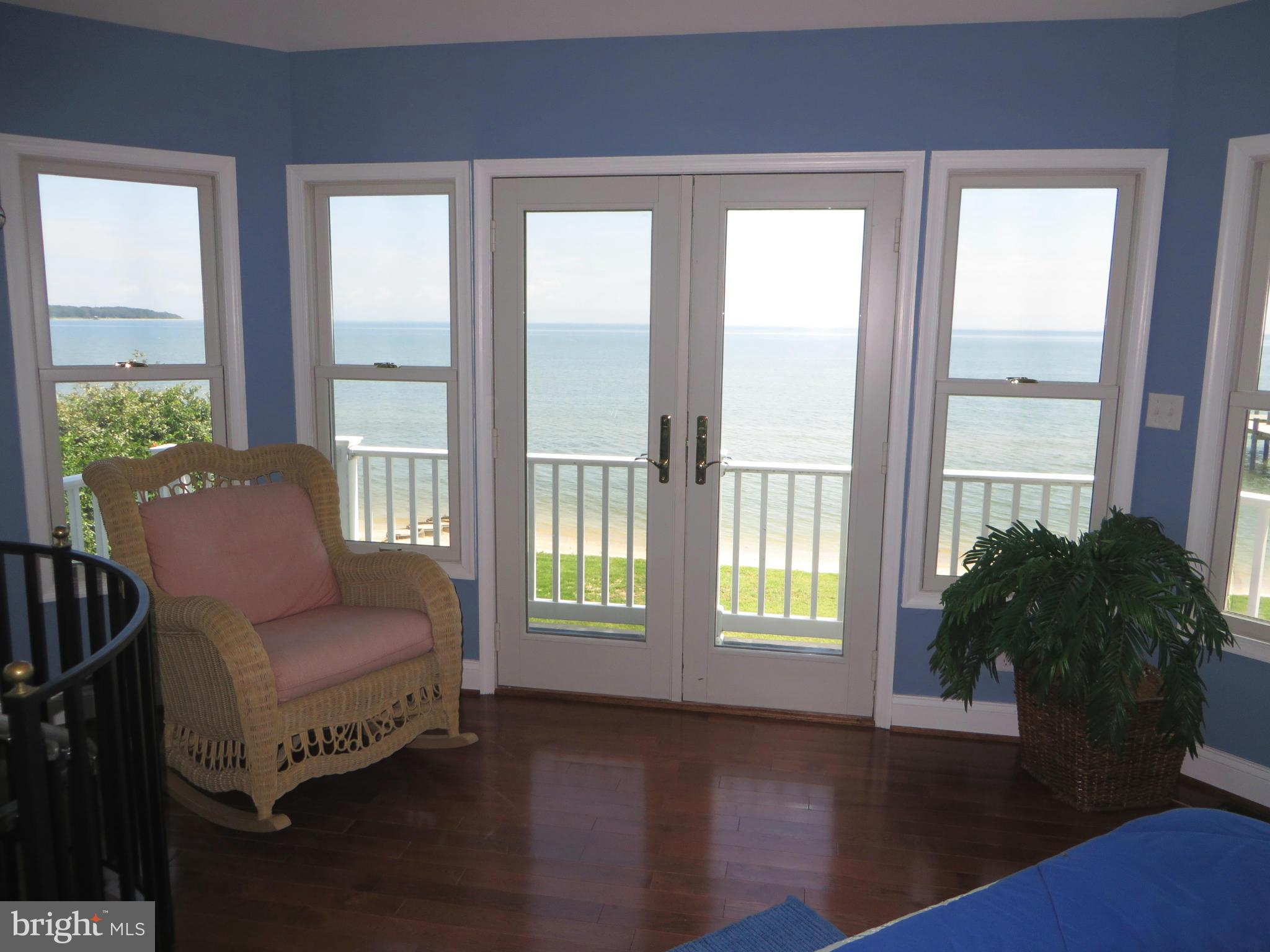 16144 Murray Road Ridge, MD 20680 - Photo 25 of 30 a living room with furniture and floor to ceiling windows