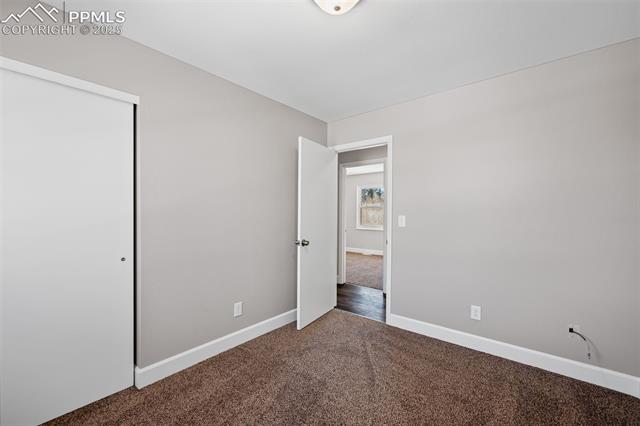 6319 Chippewa Road Colorado Springs, CO 80915 - Photo 27 of 36 Unfurnished bedroom featuring a closet and carpet flooring