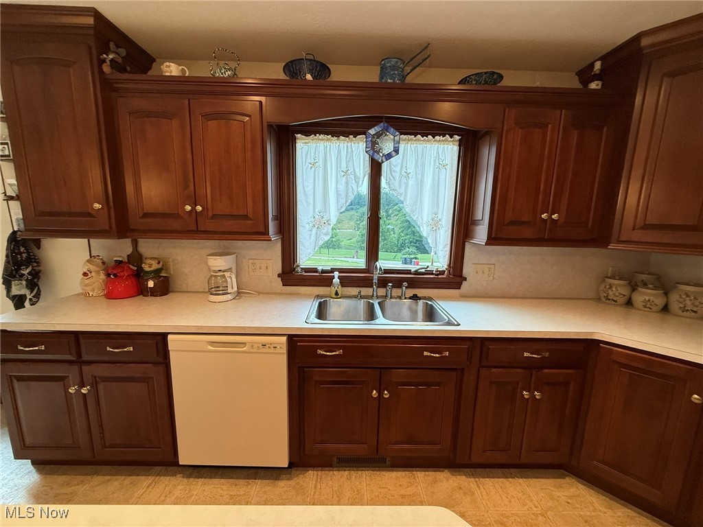 2597 Pyle Road Dover, OH 44622 - Photo 11 of 50 Kitchen featuring white dishwasher and light countertops