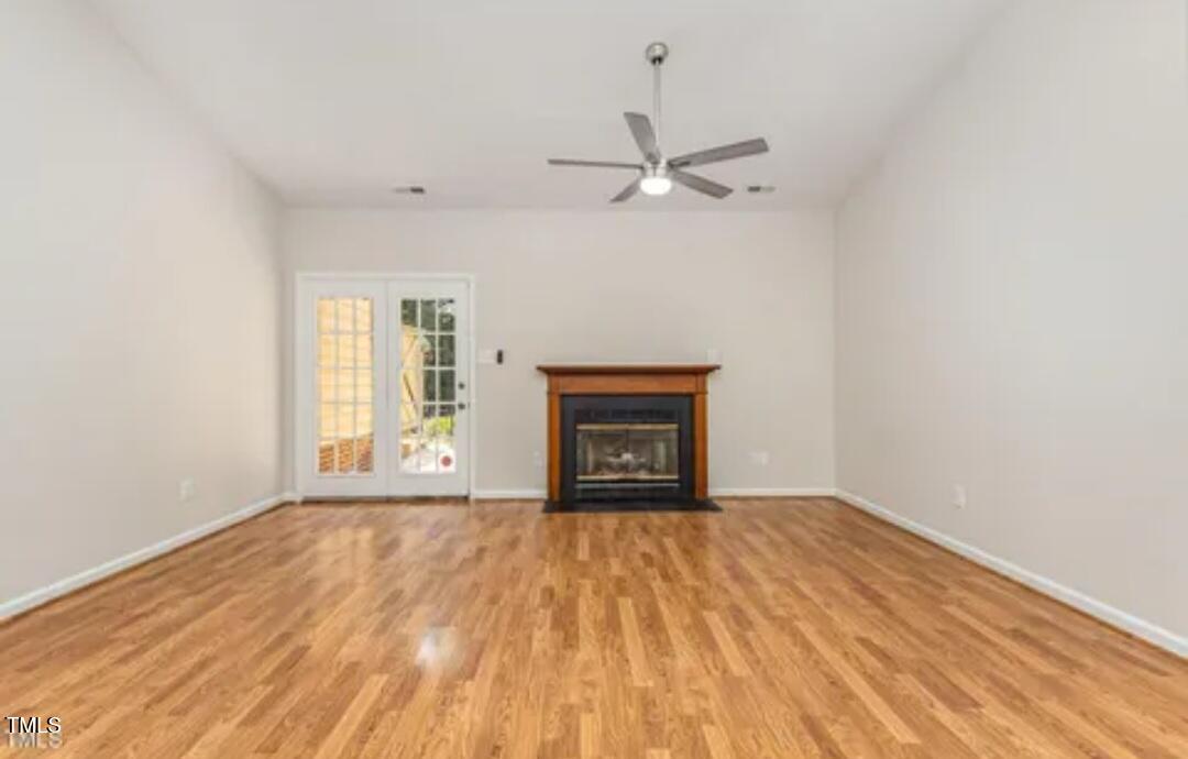 71 Stone Hill Court Durham, NC 27704 - Photo 2 of 13 a view of empty room with wooden floor and fan