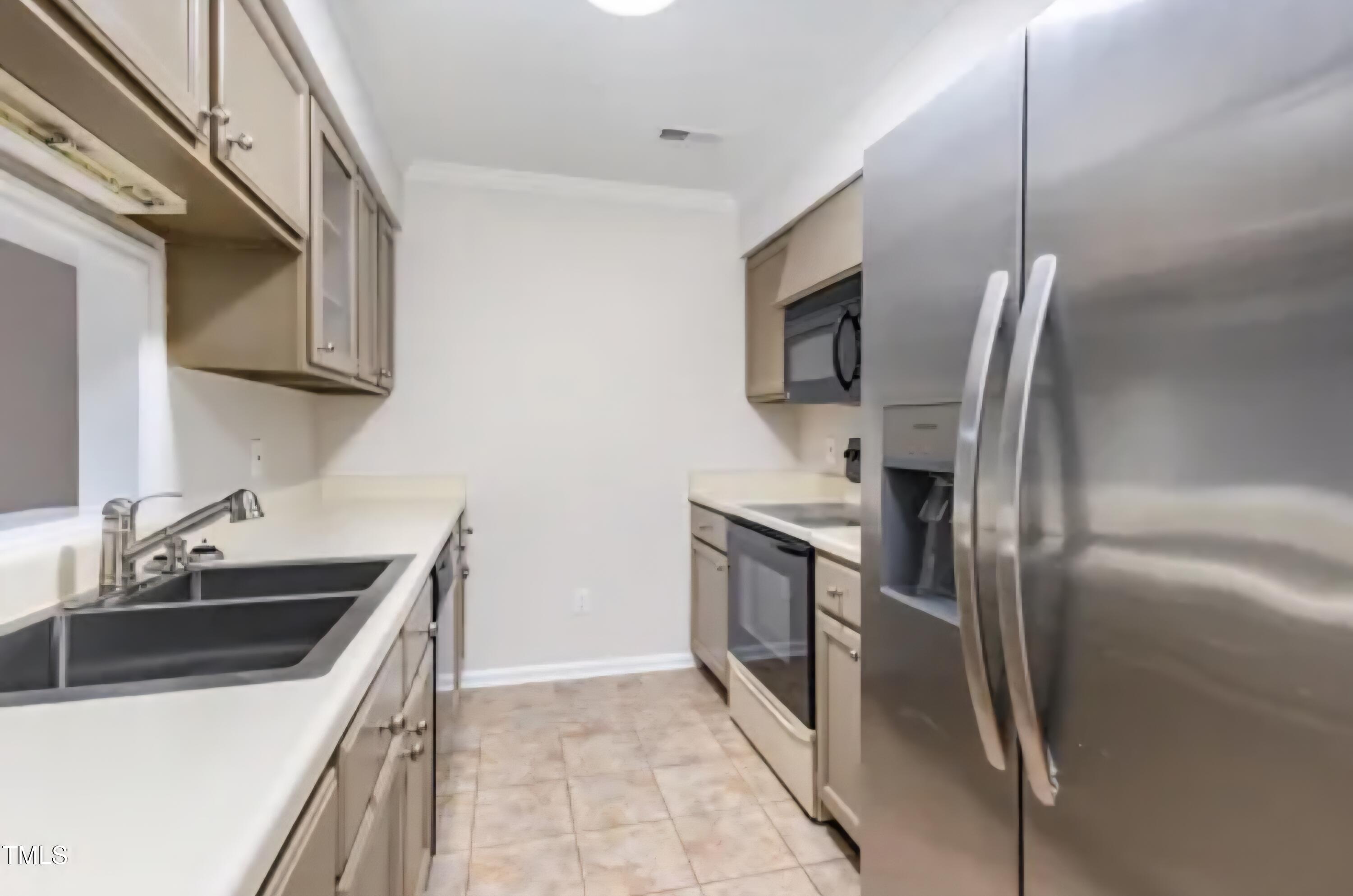 71 Stone Hill Court Durham, NC 27704 - Photo 4 of 13 a kitchen that has a sink stainless steel appliances and cabinets