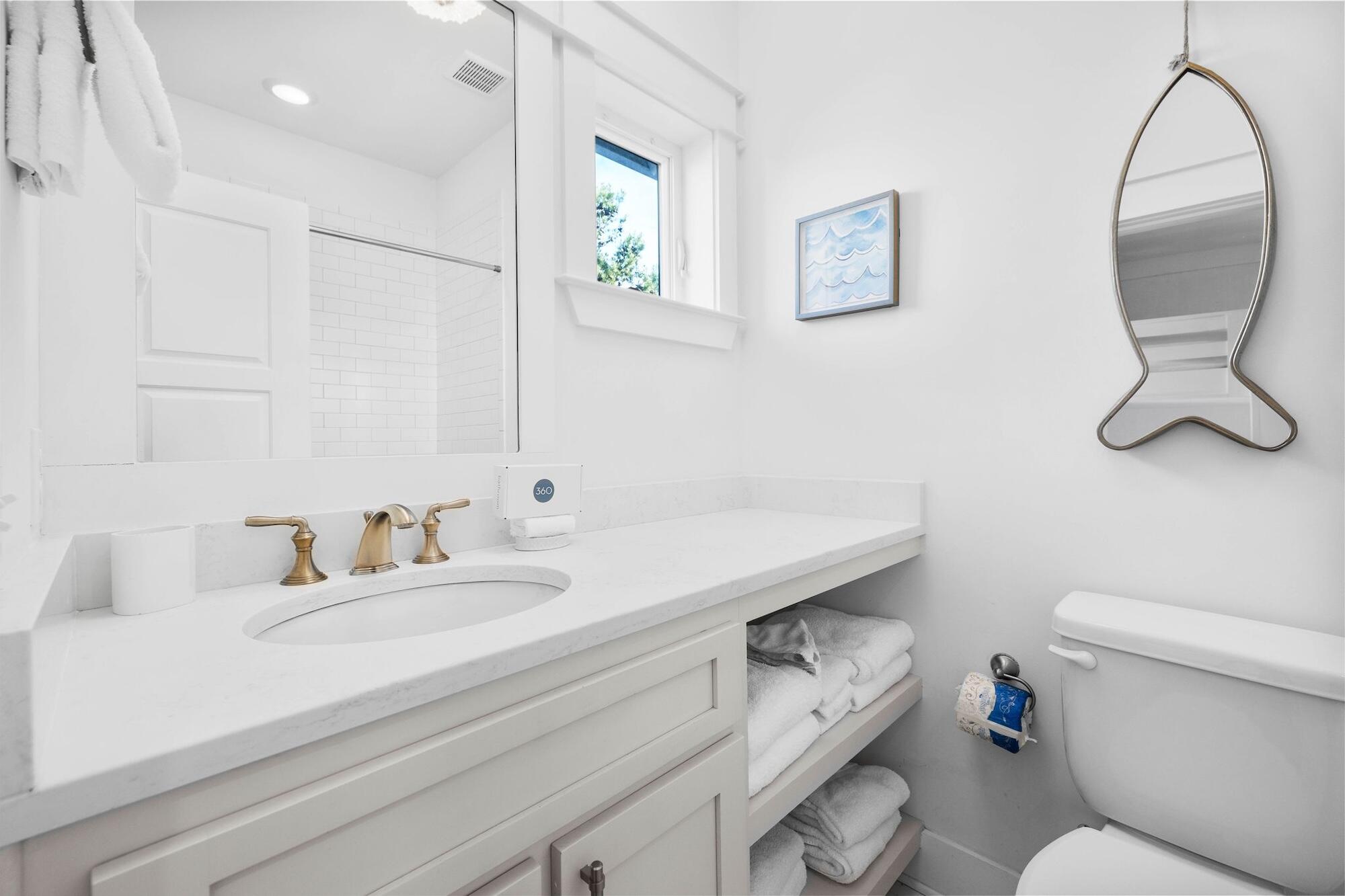 170 Seacrest Beach Boulevard East Inlet Beach, FL 32461 - Photo 13 of 38 a bathroom with a granite countertop toilet sink and mirror