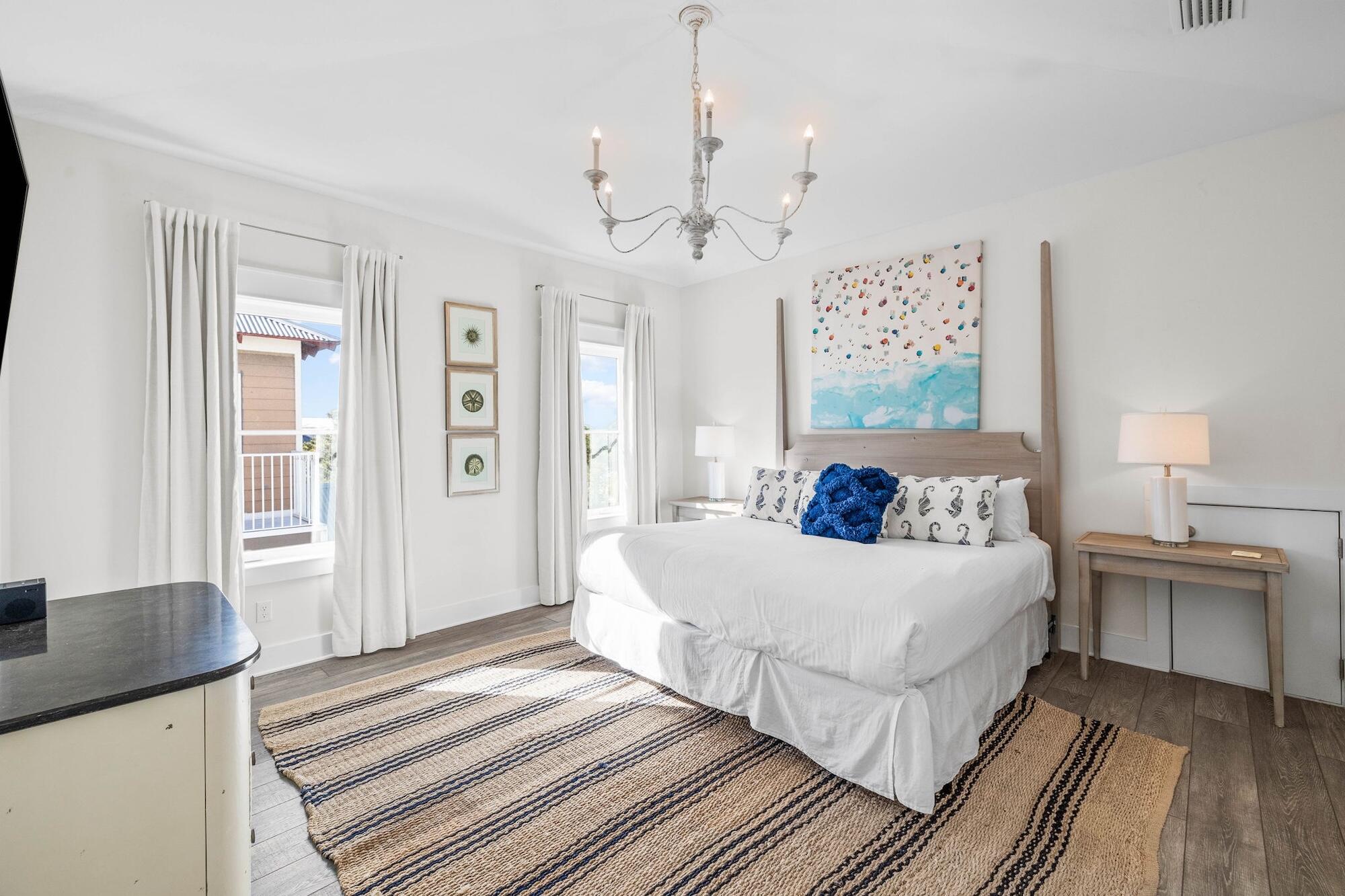 170 Seacrest Beach Boulevard East Inlet Beach, FL 32461 - Photo 15 of 38 a bedroom with a large bed and a chandelier