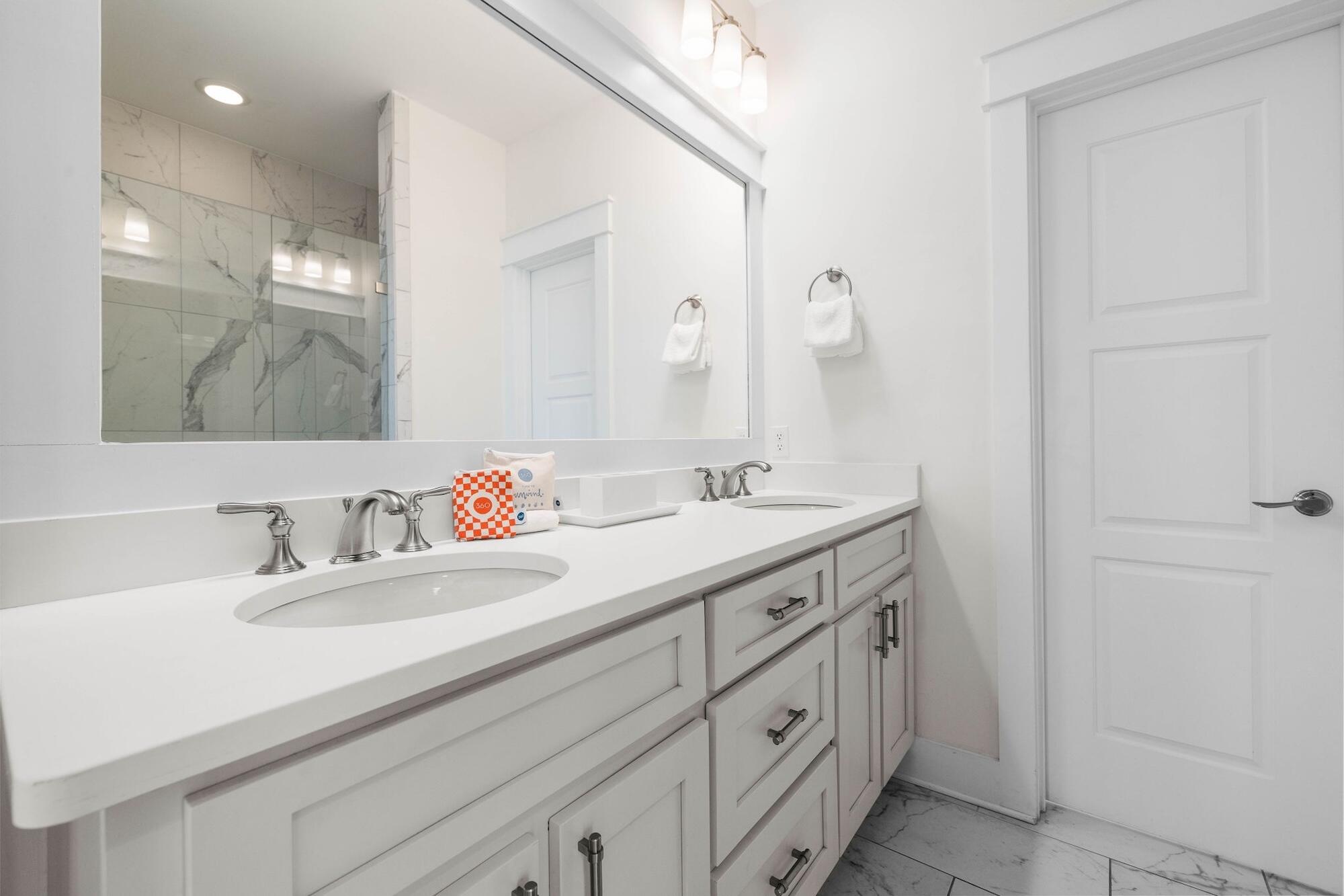 170 Seacrest Beach Boulevard East Inlet Beach, FL 32461 - Photo 21 of 38 a bathroom with a double vanity sink and mirror
