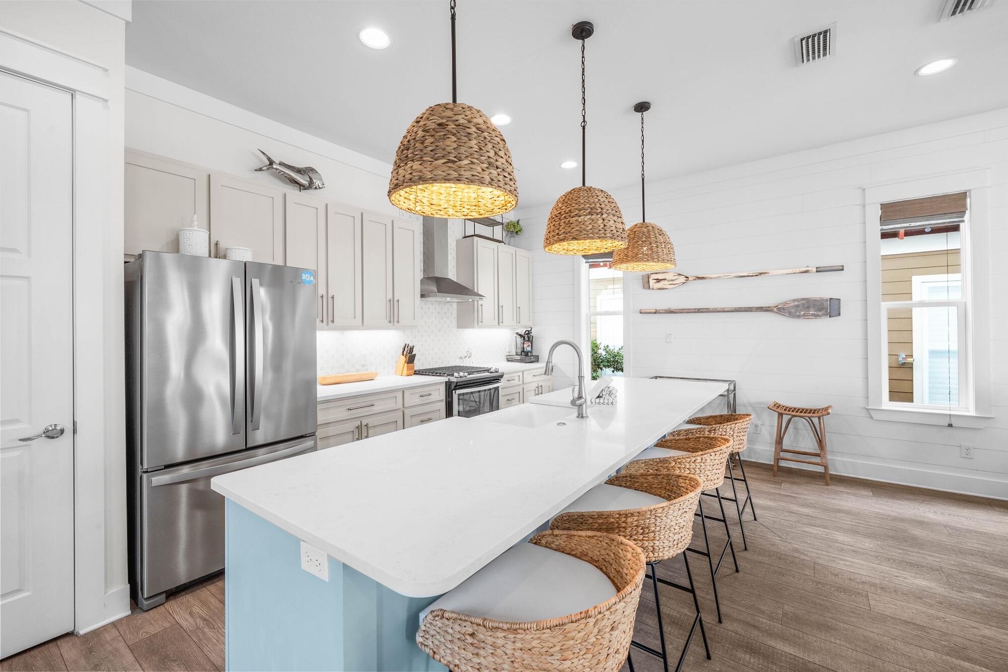 170 Seacrest Beach Boulevard East Inlet Beach, FL 32461 - Photo 5 of 38 a kitchen with stainless steel appliances a dining table chairs and a refrigerator