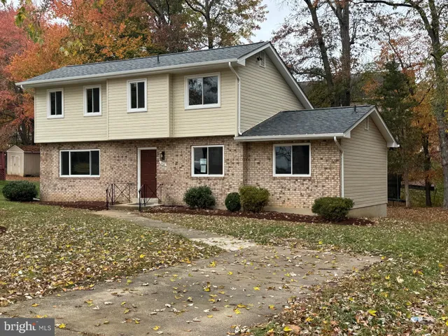 a view of a yard in front of a house with potted plants
