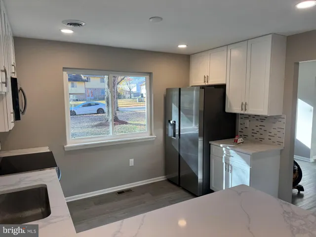 a kitchen with a refrigerator and window