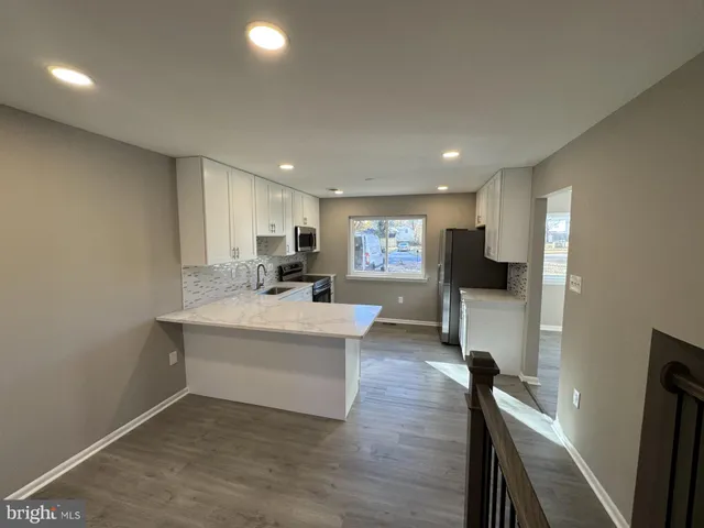 a view of kitchen with cabinets and wooden floor