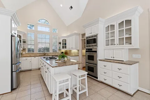 a kitchen with a stove oven and cabinets