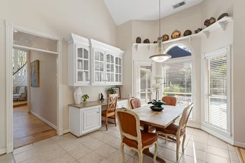 a dining room with furniture and wooden floor