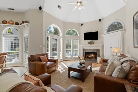 a living room with furniture fireplace and a large window