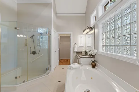 a bathroom with a tub sink and mirror