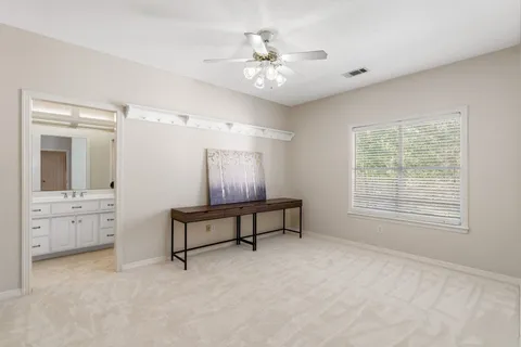 a spacious bedroom with furniture and windows