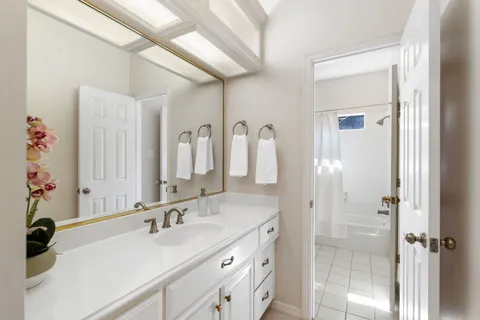 a bathroom with a double vanity sink mirror and double