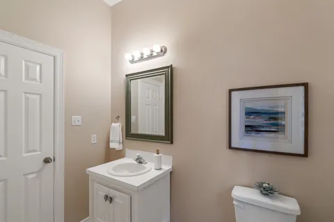 a bathroom with a toilet a sink and mirror