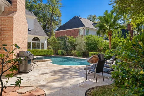 a view of a house with backyard sitting area and garden