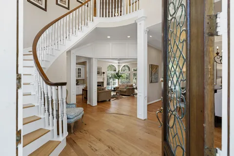 a view of an entryway with wooden floor