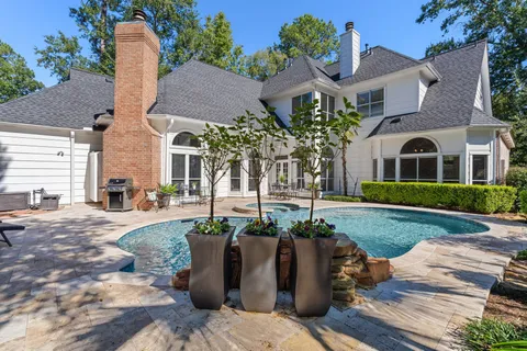 a view of a backyard with furniture and a fire pit