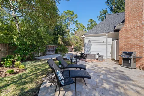an aerial view of a house with a yard and outdoor seating
