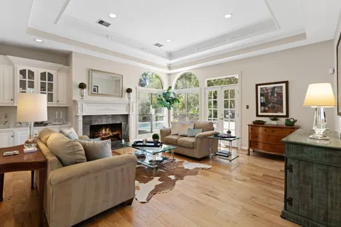 a living room with furniture large window and a fireplace