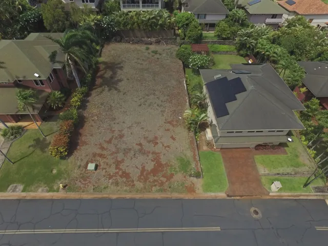 an aerial view of a house with a yard and garden