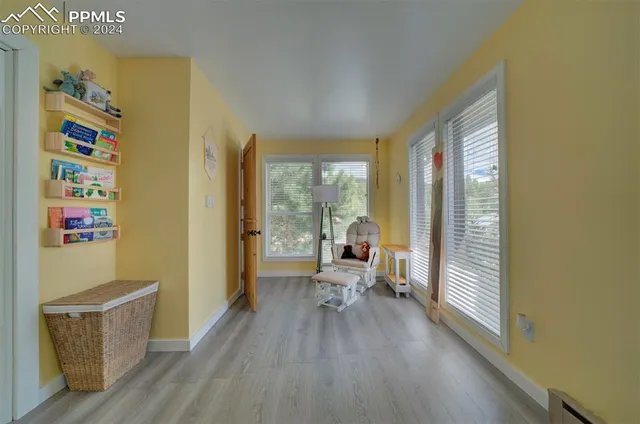 a very nice looking room with a large window and wooden floor