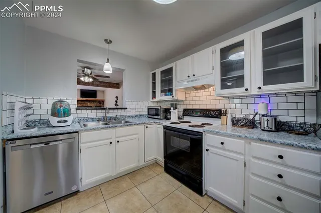 a kitchen with stainless steel appliances granite countertop a sink and a stove