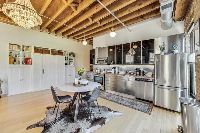 a kitchen with stainless steel appliances granite countertop a stove and a refrigerator