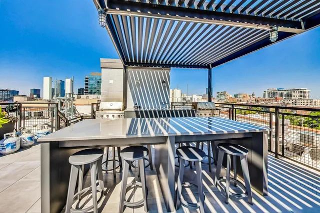 a outdoor space with lots of tables a chairs and a book shelf